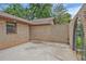 Enclosed brick patio featuring a concrete floor and iron gate, providing a private outdoor space at 4296 Linda Sw Ln, Lilburn, GA 30047