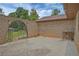 Private brick patio with an arched gate, providing a secluded outdoor space at 4296 Linda Sw Ln, Lilburn, GA 30047