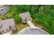 Aerial view of a brick home on a landscaped lot in a wooded neighborhood at 830 Nottingham Se Dr, Smyrna, GA 30082