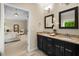Bathroom featuring a dual sink vanity with granite countertop adjacent to primary bedroom at 830 Nottingham Se Dr, Smyrna, GA 30082