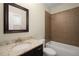 Bathroom featuring vanity with granite countertop and tiled shower and tub combo at 830 Nottingham Se Dr, Smyrna, GA 30082