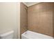 Bright bathroom features a white bathtub with tile surround at 830 Nottingham Se Dr, Smyrna, GA 30082