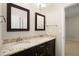Bathroom featuring a dual sink vanity with granite countertop and dark wood cabinets at 830 Nottingham Se Dr, Smyrna, GA 30082