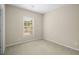 Bedroom with neutral carpet and paint, and a window providing natural light at 830 Nottingham Se Dr, Smyrna, GA 30082