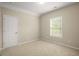 Bedroom with neutral carpet and paint and bright window providing natural light at 830 Nottingham Se Dr, Smyrna, GA 30082