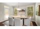An elegant dining room with modern lighting and neutral colors at 830 Nottingham Se Dr, Smyrna, GA 30082