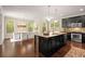 Spacious eat-in kitchen featuring black cabinetry, granite countertops, and stainless steel appliances at 830 Nottingham Se Dr, Smyrna, GA 30082