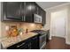Well-equipped kitchen featuring granite countertops, stainless steel appliances, and plenty of cabinet space at 830 Nottingham Se Dr, Smyrna, GA 30082