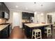 Stylish kitchen with an island, dark cabinets, stainless steel appliances, and hardwood floors at 830 Nottingham Se Dr, Smyrna, GA 30082