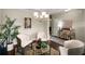 Inviting living room featuring a round table, hardwood floors, stylish decor, and soft natural light at 830 Nottingham Se Dr, Smyrna, GA 30082