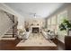 Sunlit living room with fireplace and staircase, ideal for relaxation at 830 Nottingham Se Dr, Smyrna, GA 30082