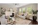 Bright living room with large windows, a fireplace, and stylish decor at 830 Nottingham Se Dr, Smyrna, GA 30082
