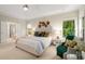 Spacious main bedroom with sitting area, windows, and elegant decor at 830 Nottingham Se Dr, Smyrna, GA 30082