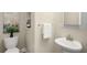 Cozy powder room with a white vanity sink, decorative mirror, and neutral wall paint at 830 Nottingham Se Dr, Smyrna, GA 30082