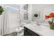 Well-lit bathroom with a shower-tub combo, vanity, and decorative floral accents at 1095 Elowen Dr, Austell, GA 30168