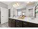 Bathroom featuring double vanity with white countertop and shower with decorative tile at 1095 Elowen Dr, Austell, GA 30168