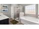 Bright bathroom features tiled walls, soaker tub, a glass enclosed shower and a vanity at 1095 Elowen Dr, Austell, GA 30168