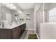 Spacious bathroom featuring double sinks, framed mirrors and a glass enclosed shower at 1095 Elowen Dr, Austell, GA 30168