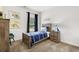 bedroom with a wooden bed frame, dinosaur decorations, and a window with blue curtains at 1095 Elowen Dr, Austell, GA 30168