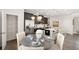 Open concept kitchen and dining area with stainless steel appliances, white countertops, and seating at the island at 1095 Elowen Dr, Austell, GA 30168