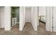 Hallway view to the laundry room and bedroom with plush carpeted floors and white walls at 1095 Elowen Dr, Austell, GA 30168