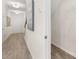 Clean, bright hallway with wood-look flooring, neutral walls, and view of stairs and closet at 1095 Elowen Dr, Austell, GA 30168