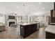 Open kitchen with a large island, stainless steel appliances, and views into the living room with a fireplace at 1095 Elowen Dr, Austell, GA 30168