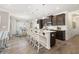 Open-concept kitchen with a large island, stainless steel appliances, and modern dark brown cabinetry at 1095 Elowen Dr, Austell, GA 30168