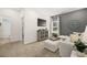 Inviting living room with gray accent wall, plush seating, and an open view of the hall at 1095 Elowen Dr, Austell, GA 30168