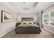 Comfortable main bedroom showcasing tray ceilings, large windows and ample natural light at 1095 Elowen Dr, Austell, GA 30168