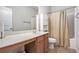 Well-lit bathroom with vanity, framed mirror, tiled floor, and shower over tub at 5152 Rapahoe Trl, Atlanta, GA 30349