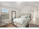 Comfortable bedroom with a bed, mirror, window, and neutral decor at 5152 Rapahoe Trl, Atlanta, GA 30349