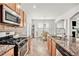 Modern kitchen with granite countertops, stainless steel appliances, and open access to the dining area for seamless entertaining at 5152 Rapahoe Trl, Atlanta, GA 30349