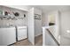 Convenient upstairs laundry room with modern washer and dryer, plus added shelving at 5152 Rapahoe Trl, Atlanta, GA 30349