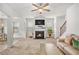 Comfortable living room with a fireplace, large windows, and a ceiling fan, creating a warm and inviting space at 5152 Rapahoe Trl, Atlanta, GA 30349