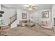 Inviting living room with plush carpeting, staircase, and neutral walls providing a comfortable and stylish atmosphere at 5152 Rapahoe Trl, Atlanta, GA 30349