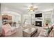 Open-concept living room with a fireplace, plush seating, and seamless flow into the kitchen and dining area at 5152 Rapahoe Trl, Atlanta, GA 30349