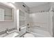 A bright bathroom features a granite topped vanity and shower-tub combination at 7262 Sandpiper Way, Riverdale, GA 30274