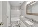This bathroom features granite countertops, marble floors, and a shower-tub combo at 7262 Sandpiper Way, Riverdale, GA 30274
