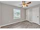 The bedroom has hard surface floors, ceiling fan, and large window at 7262 Sandpiper Way, Riverdale, GA 30274