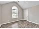 Bright bedroom featuring gray walls, wood-look flooring, a large window and a vaulted ceiling at 7262 Sandpiper Way, Riverdale, GA 30274