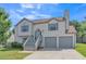 Charming two-story home boasts a well-manicured lawn, gray stairs and a two-car garage at 7262 Sandpiper Way, Riverdale, GA 30274
