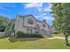 Inviting two-story home with manicured lawn, illuminated landscaping, gray stairs, and two-car garage at 7262 Sandpiper Way, Riverdale, GA 30274