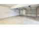 Spacious garage featuring two garage doors and a white brick wall at 7262 Sandpiper Way, Riverdale, GA 30274