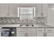 Kitchen featuring a stainless steel dishwasher, sink, and granite countertops at 7262 Sandpiper Way, Riverdale, GA 30274
