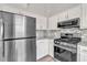 Modern kitchen boasting stainless steel appliances, granite countertops, and ample cabinet space at 7262 Sandpiper Way, Riverdale, GA 30274