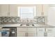 Kitchen featuring stainless steel dishwasher, double sink, and granite countertops at 7262 Sandpiper Way, Riverdale, GA 30274