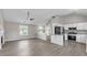 Open-concept living room with a fireplace, neutral paint, and lots of natural light at 7262 Sandpiper Way, Riverdale, GA 30274