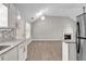 Open living space with a modern kitchen and stainless steel refrigerator at 7262 Sandpiper Way, Riverdale, GA 30274