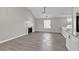 Bright living area features a marble fireplace, high ceiling, and modern gray flooring at 7262 Sandpiper Way, Riverdale, GA 30274